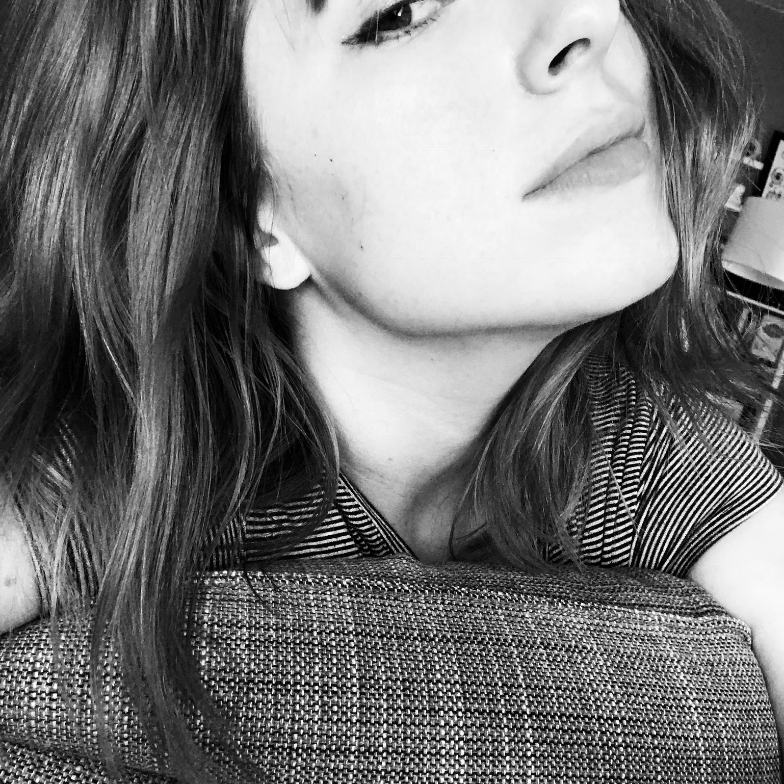 Black and white close-up of a person wearing a patterned garment.