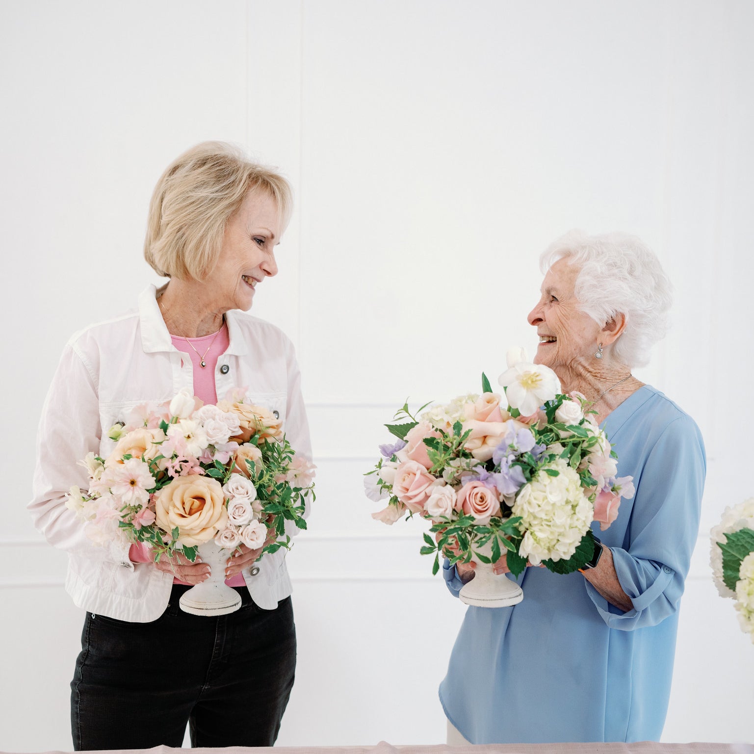 women making flower arrangements with friends